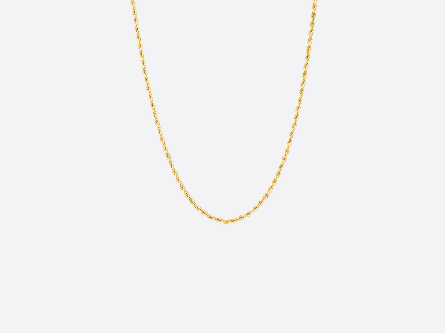 Gold chain necklace on a light gray background