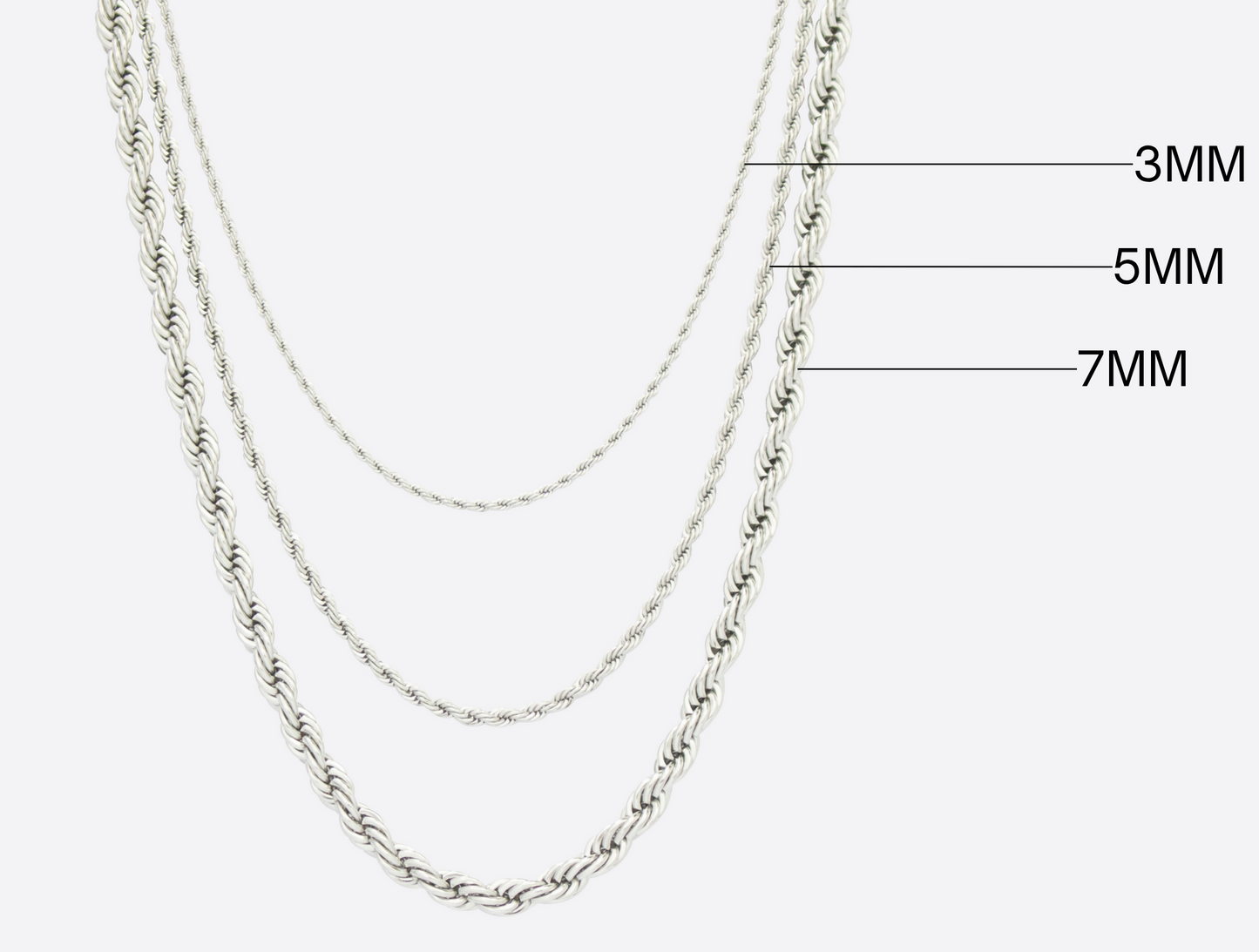 Three silver chains of different widths on a white background