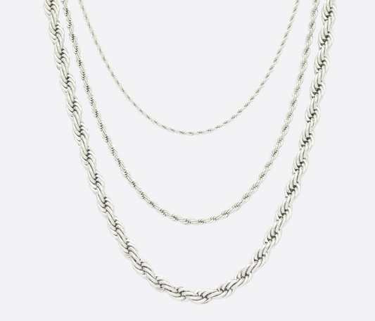 Three silver chain necklaces on a white background