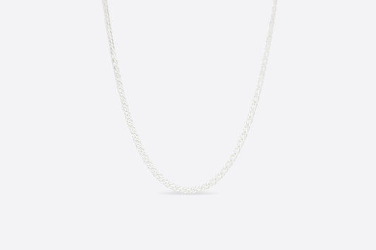 CUBAN NECKLACE A White necklace on a light gray background